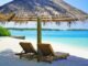 Lounge Chairs Under Thatched Umbrella at the Beach